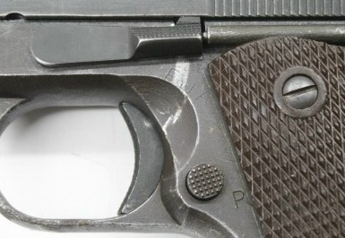 Close-up of an idiot scratch — a cosmetic mark left on a pistol's frame from an unprotected slide stop during disassembly